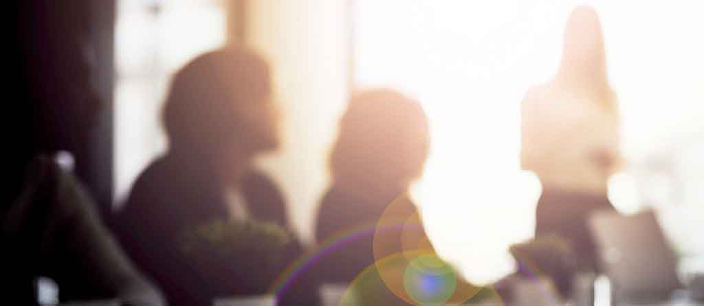 Image of coworkers in a meeting room
