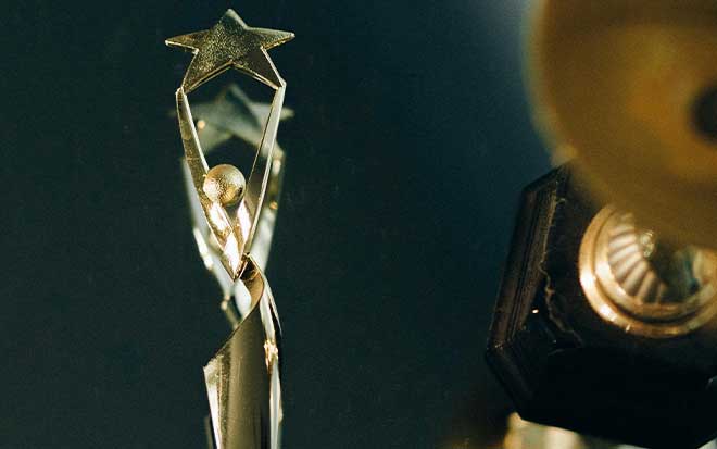 A trophy is shown against a darker background.
