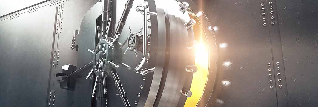 Large circular vault door partially open with light shining through